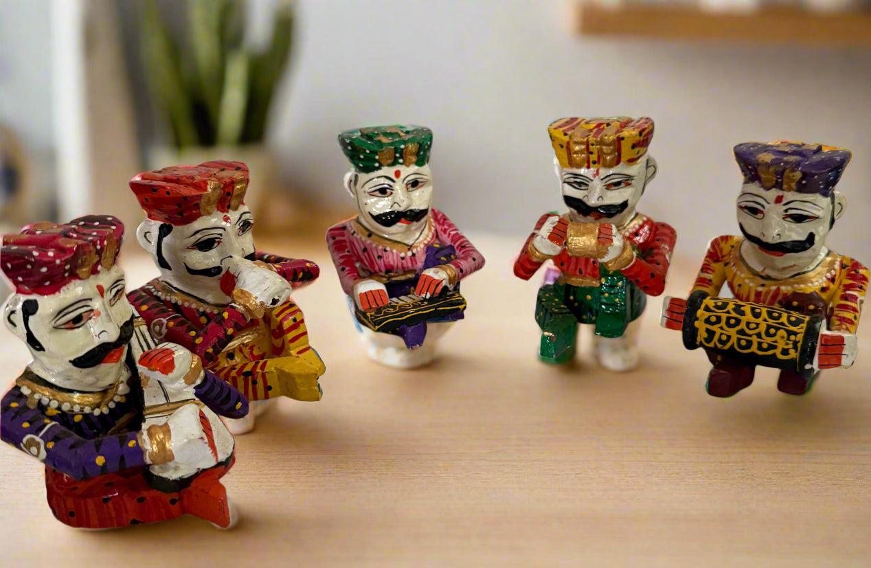 Colorful figurines on a marble surface with a white wall background