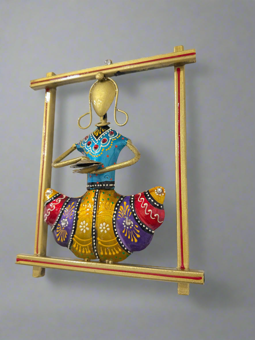 Decorative wall art of a colorful figure in a gold frame on a white background