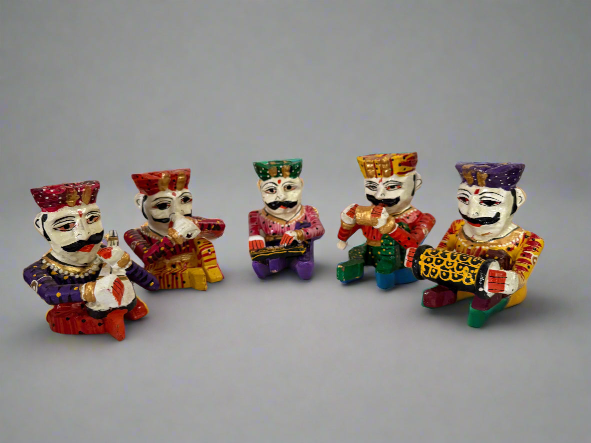 Five colorful figurines of men with different hairstyles and clothing on a white surface.
