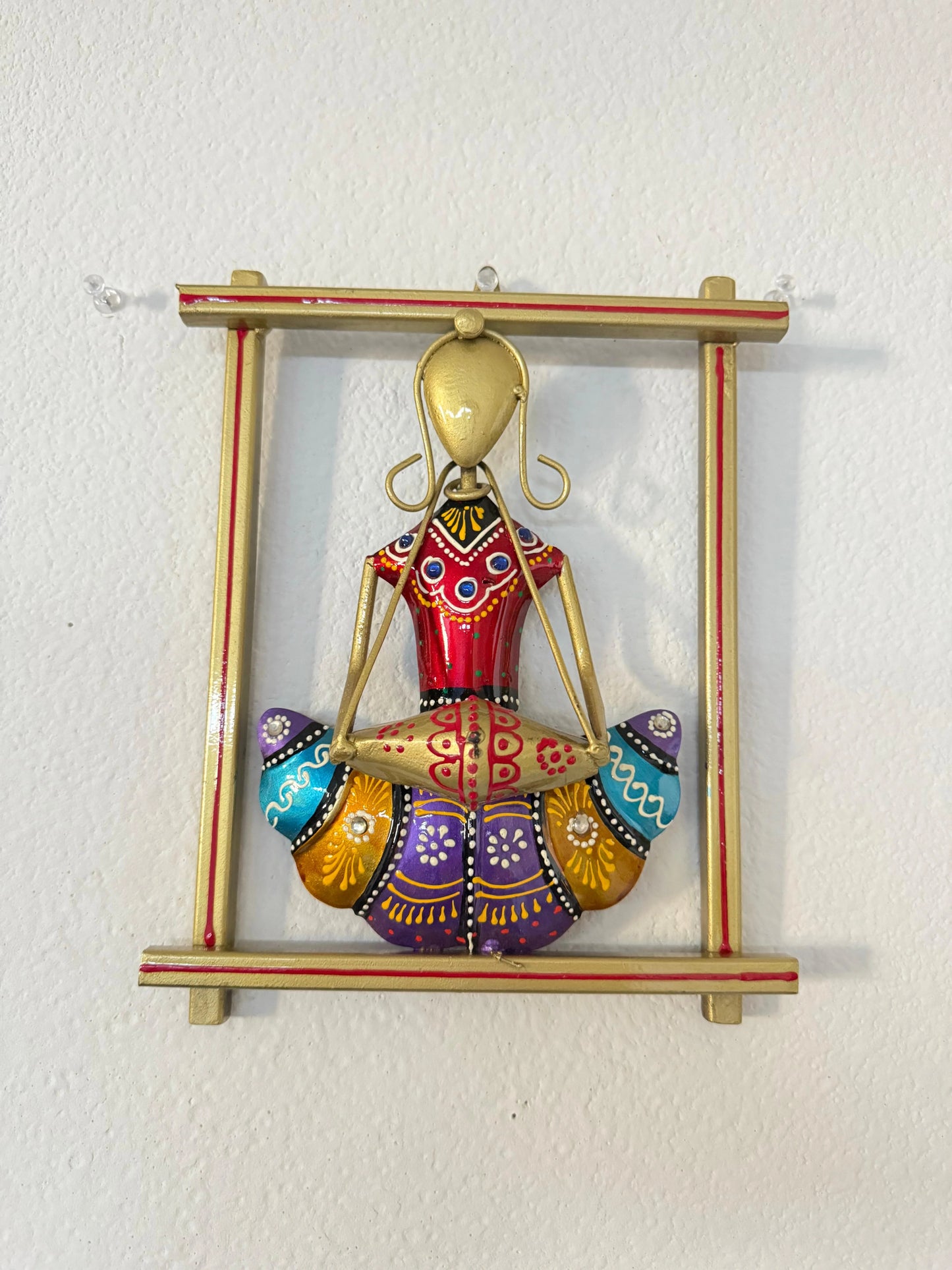 Decorative wall hanging with a colorful figure on a white background