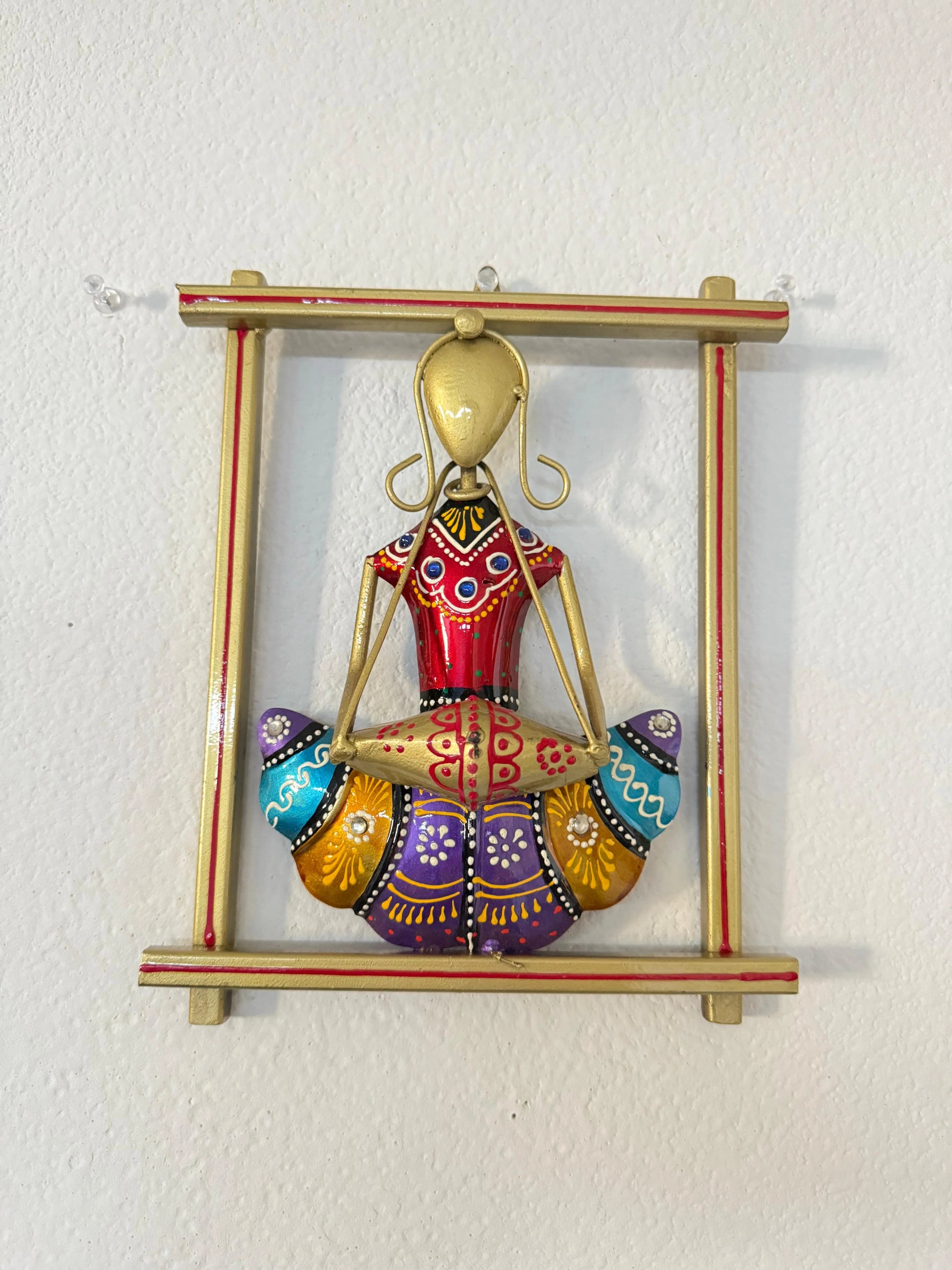 Decorative wall hanging with a colorful figure on a white background